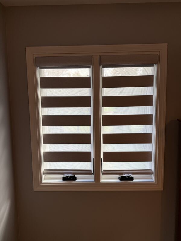 Banded shades closed down for privacy in a back bedroom.