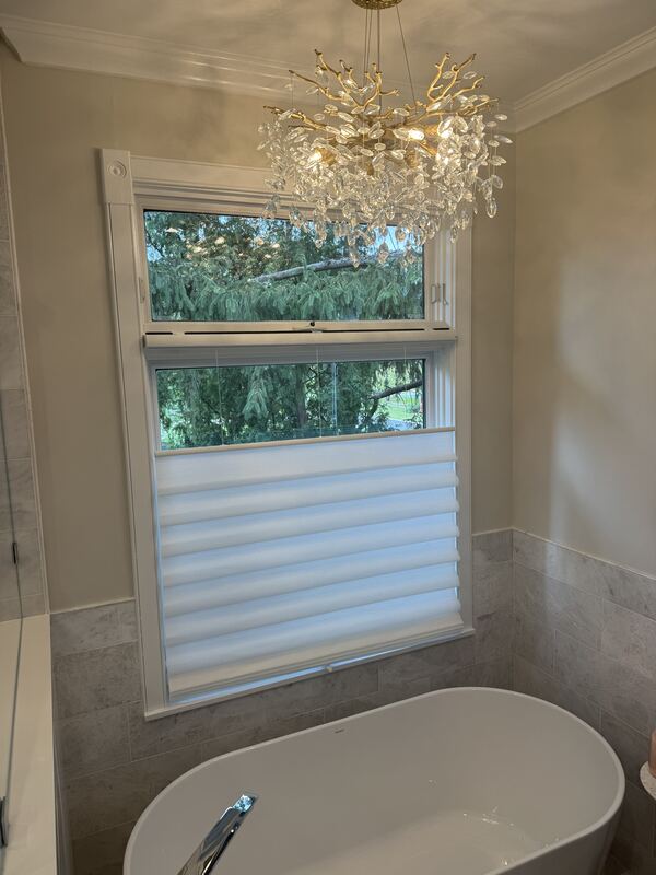 Soft, light-filtering fabric over obscured glass - daylight without exposure.