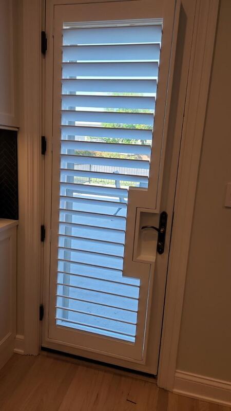 Newstyle Hybrid Shutters with Door handle cut out.