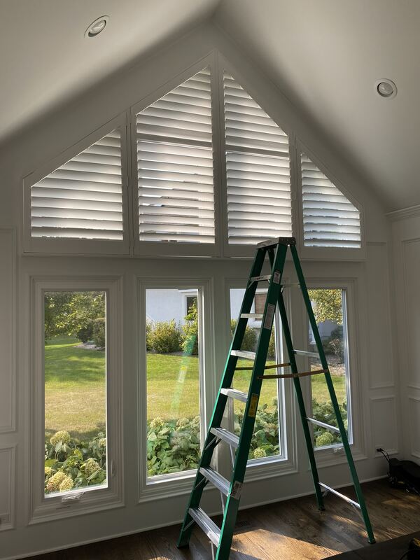 Specialty-shape shutters in a gable, built to the pitch of the roofline.